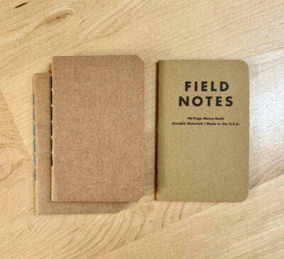 confluye notebook next to field notes