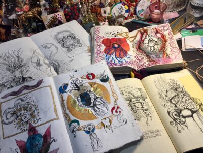 open sketchbooks full of art